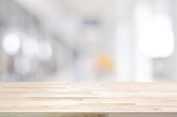 Wood table top on blurred hallway background