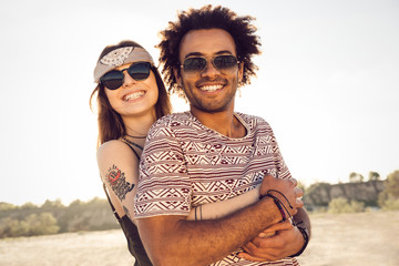 Wall Mural - Happy young couple embracing on the beach