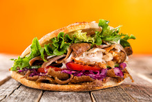 Close Up Of Kebab Sandwich On Old Wooden Table.