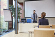 © Westend61 - Coach talking to woman in training room