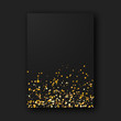 Black paper poster sheet with shiny glam golden glitter sparks on black background