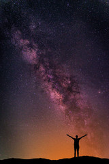 Wall Mural - landscape with milky way galaxy. night sky with stars and silhouette happy man on the mountain. long