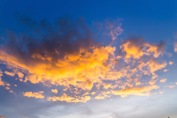 Wall Mural - sunset / sun rise sky with rays of yellow and red light shining clouds and sky background and textur