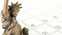 Gold Bronze Metallic Statue Of Liberty National Monument On Grid Of Dates In July Of Desk Calendar Page, Independence Day Or American National Day Concept, Close-up With Copy Space
