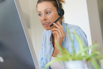 Wall Mural - Customer service operator talking on phone in office