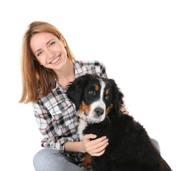 Wall Mural - Young woman with cute funny dog on white background