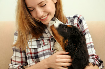 Wall Mural - Young woman with cute funny dog at home