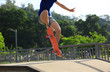 © lzf - young woman skateboarder skateboarding at skatepark