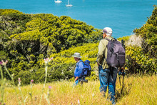 Two Photographers Standing On A Hillside Of Angel Island In The Middle Of San Francisco Bay