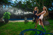 Women watering with garden hose