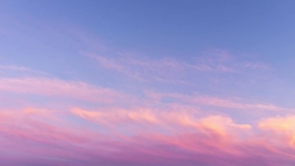 Wall Mural - time lapse of pink clouds and blue sky at sunset.