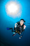 Beautiful Scuba diver smile with underwater Ambient light in the blue sea.