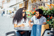 © Iryna - Young African American Couple In Love Drinking Coffee In City Street Cafe In Vacation Summer Time. Love Holiday and relationship concept