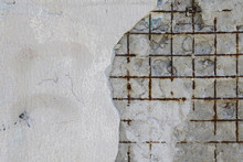On The Old Wall Part Of The Plaster Fell Off And A Rusty Metal Grid Is Visible. Background For Your Design