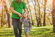 © kegfire - Lovely girl walking with grandfather in park