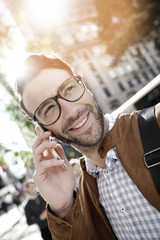 Trendy businessman in Manhattan talking on phone