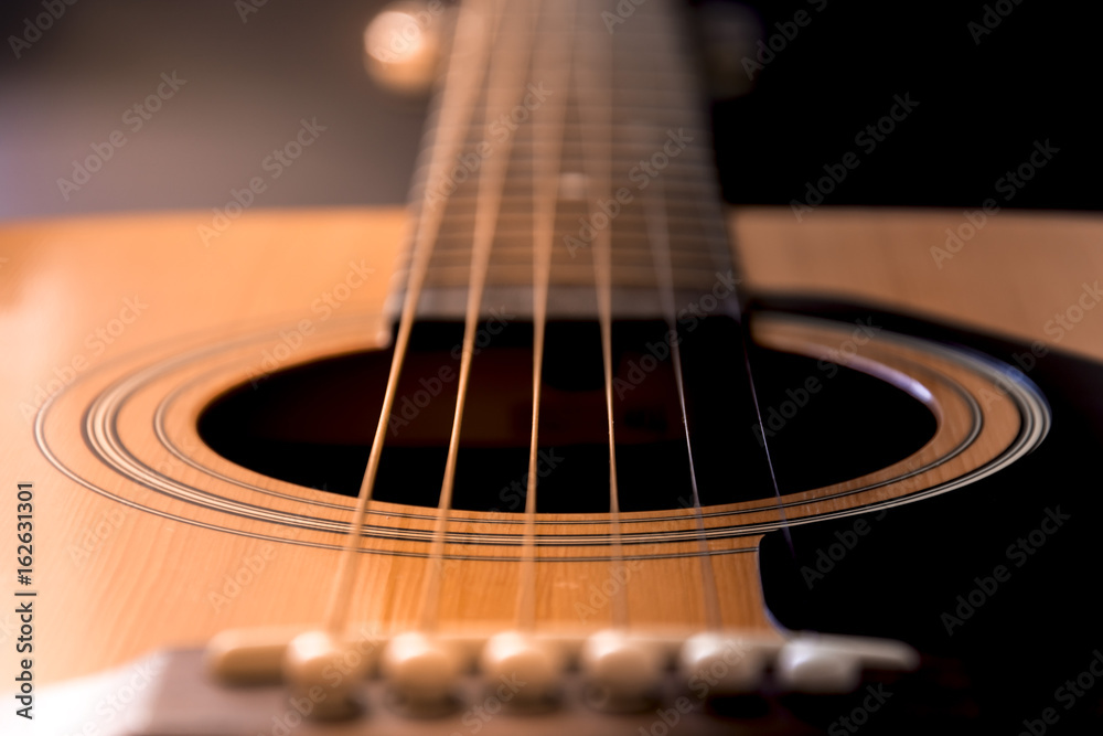 Detail of guitar. View on guitar strings. Wooden musical instrument. - obrazy, fototapety, plakaty 