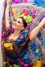 Beautiful Smiling Mexican Woman In Traditional Mexican Dress Hands Up Holding The Skirt As A Background Like Peacock