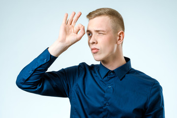 Wall Mural - Young man looking far away isolated on white