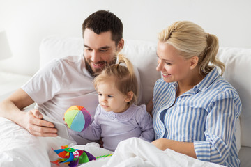 Wall Mural - happy family with smartphone in bed at home