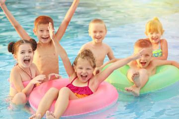 Poster - Little kids in swimming pool on sunny day