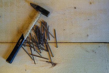 Hammer and nails on a wooden board