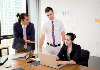 Wall Mural - Business team having using laptop during a meeting and presents.