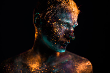 Portrait of a man painted in fluorescent UV colors.