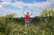 © aneduard - Girl with a backpack standing on the background of the lake and drinking water
