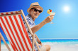 © Ljupco Smokovski - Mature man sitting in a deck chair on a beach
