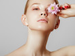 © looking2thesky - Aesthetic Cosmetology. Spring Woman. Beauty Summer model girl with colorful flowers . Beautiful Lady with Blooming flowers. Holiday Fashion Makeup.