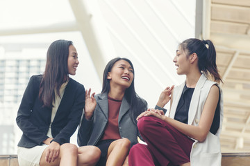 Happy female friends  at meeting outdoors in the city