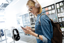 Smart Female Student Shopping For Headphones