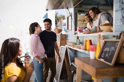 Fotografía Couple interacting with each other at food truck van