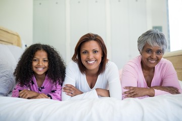 Wall Mural - Happy family lying on bed in bed room