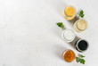 Set of dressings for salad: sauce vinaigrette, mustard, mayonnaise or ranch, balsamic or soy, basil with yogurt. Dark white concrete table. Copy space top view