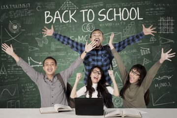 Wall Mural - Cheerful students with scribble on blackboard