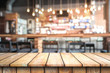© satit - Empty wood top table with space for display product in Blurred cafe background.