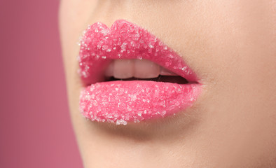 Wall Mural - Woman with sugar lips on color background, closeup