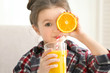 © Africa Studio - Cute little girl drinking juice at home, closeup