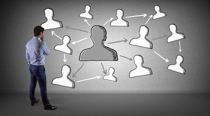 Wall Mural - Businessman watching social network sketch on a wall 3D rendering