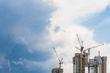 Highrise tower crane and new unfinished residential townhouse under construction