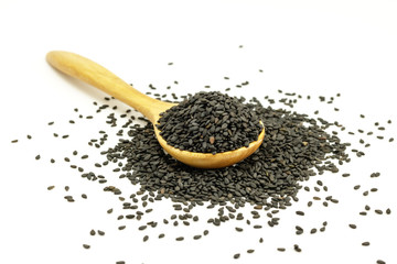Wall Mural - Black Sesame Seeds  with wooden spoon on white background. Composition isolated over the white background.