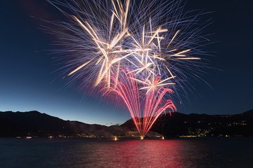 Fireworks on the lake in a summer night