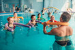 © Nomad_Soul - Aqua aerobics exercises, women with male trainer