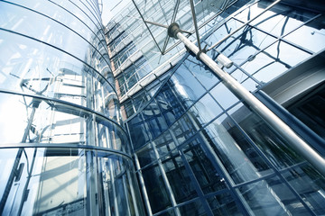 Wall Mural - Office building detail low angle view, steel structure and glass roof photographed from below