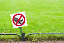 A Sign Warning People To Keep Off Of The Grass In The Park.