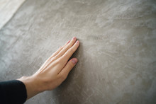 Young Man Hand Touching Concrete Wall