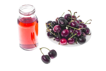 Canvas Print - Ripe red cherry and juice from it in glass on white background.