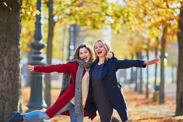 Wall Mural - Two young girls on a sunny fall day